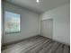 Bedroom with a large window, wooden floors and a closet with folding doors at 135 Sunset Rd, Rotonda West, FL 33947