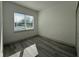 Light-filled bedroom with a large window, gray floors and bright white walls at 135 Sunset Rd, Rotonda West, FL 33947