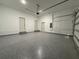 Spacious garage with epoxy floor and white walls with two utility doors at 135 Sunset Rd, Rotonda West, FL 33947