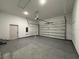 Spacious garage with speckled flooring and a modern automatic door for convenient parking and storage at 135 Sunset Rd, Rotonda West, FL 33947