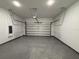 Spacious garage with epoxy floor and white walls at 135 Sunset Rd, Rotonda West, FL 33947