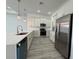 Modern kitchen with white cabinets, stainless steel appliances, and a quartz countertop island at 135 Sunset Rd, Rotonda West, FL 33947