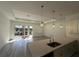 Open concept living space with recessed lights, pendant lighting, and sliding doors to the patio at 135 Sunset Rd, Rotonda West, FL 33947