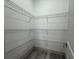 Walk-in pantry with metal shelving, ample storage space and gray floors at 135 Sunset Rd, Rotonda West, FL 33947