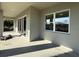 An outdoor covered patio area with large glass sliding doors, perfect for entertaining or relaxing at 135 Sunset Rd, Rotonda West, FL 33947