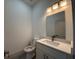 Powder room with modern vanity, granite countertop and chrome faucet at 135 Sunset Rd, Rotonda West, FL 33947