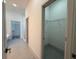 Bright walk-in closet features wire shelving, grey tile floor, and a view into the main bathroom at 135 Sunset Rd, Rotonda West, FL 33947
