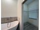 Bright walk-in closet with wire shelving, a window, and wood flooring at 135 Sunset Rd, Rotonda West, FL 33947