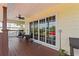 Back porch with sliding glass doors, wicker chairs and potted plants at 505 Sally Lee Dr, Ellenton, FL 34222