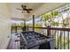 Covered back porch with foosball table, ceiling fan and grilling area at 505 Sally Lee Dr, Ellenton, FL 34222