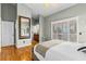 Main bedroom with hardwood floors, a full-length mirror, and access to a balcony at 505 Sally Lee Dr, Ellenton, FL 34222