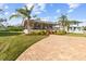 House exterior with a paver driveway and lush landscaping at 505 Sally Lee Dr, Ellenton, FL 34222