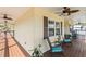 Relaxing front porch with rocking chairs, ceiling fans, and potted plants at 505 Sally Lee Dr, Ellenton, FL 34222