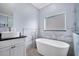 Bathroom with a modern soaking tub and floating vanity at 8115 61St N St, Pinellas Park, FL 33781