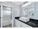 Clean bathroom, featuring a white sink, dark countertop and shower at 8115 61St N St, Pinellas Park, FL 33781