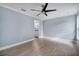 Spacious bedroom with light grey walls, ceiling fan, and wood-look flooring at 8115 61St N St, Pinellas Park, FL 33781