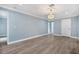 Large bedroom with wood-look floors and chandelier at 8115 61St N St, Pinellas Park, FL 33781