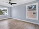 Bright bedroom with wood-look floors and ceiling fan at 8115 61St N St, Pinellas Park, FL 33781
