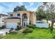Two-story house with attached garage, landscaping, and a white fence at 8115 61St N St, Pinellas Park, FL 33781
