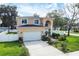 Two-story house with attached garage, landscaping, and a white fence at 8115 61St N St, Pinellas Park, FL 33781