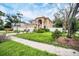 Two-story house with attached garage, landscaping, and a white fence at 8115 61St N St, Pinellas Park, FL 33781