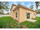 Tan two-story house with sliding glass doors and grassy backyard at 8115 61St N St, Pinellas Park, FL 33781