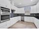Modern white kitchen with granite counters and mosaic backsplash at 8115 61St N St, Pinellas Park, FL 33781