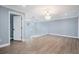Open landing with wood-look floors and modern chandelier at 8115 61St N St, Pinellas Park, FL 33781