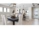 Elegant dining room with a large table and modern lighting fixture at 14370 Hammock Oak St, Parrish, FL 34219