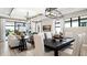 Open concept dining area with large table and access to the living room at 14370 Hammock Oak St, Parrish, FL 34219