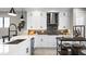 Modern kitchen with white cabinets, quartz countertops and a large island at 14370 Hammock Oak St, Parrish, FL 34219