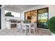 Covered patio with outdoor kitchen and comfortable seating at 14370 Hammock Oak St, Parrish, FL 34219