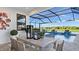 Inviting pool area with covered patio and serene water view at 14370 Hammock Oak St, Parrish, FL 34219