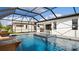 Luxury pool with spa and covered patio; outdoor kitchen at 14370 Hammock Oak St, Parrish, FL 34219