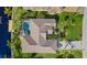 Top-down view of house, pool, and canal-front lot at 15392 Taurus Cir, Port Charlotte, FL 33981