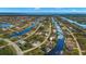 Wide aerial showcasing home's waterfront location at 15392 Taurus Cir, Port Charlotte, FL 33981