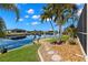 Landscaped backyard with canal views and dock at 15392 Taurus Cir, Port Charlotte, FL 33981