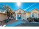 Front view of a house with a teal door and palm trees at 15392 Taurus Cir, Port Charlotte, FL 33981