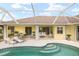 Relaxing pool and patio area with seating at 15392 Taurus Cir, Port Charlotte, FL 33981