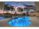 Illuminated kidney-shaped pool with screened enclosure at 15392 Taurus Cir, Port Charlotte, FL 33981