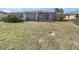 Large backyard with screened patio and grassy area at 2092 Nuremberg Blvd, Punta Gorda, FL 33983