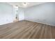 Light bedroom with wood-look flooring and access to bathroom at 2092 Nuremberg Blvd, Punta Gorda, FL 33983