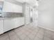 Bright kitchen features white cabinets, tile floors, and a dishwasher at 2092 Nuremberg Blvd, Punta Gorda, FL 33983