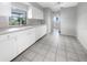 White kitchen with tile floor and view into adjacent room at 2092 Nuremberg Blvd, Punta Gorda, FL 33983
