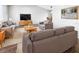 Bright living room featuring comfy sofas, a coffee table, and a large TV at 2092 Nuremberg Blvd, Punta Gorda, FL 33983