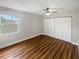 Bright bedroom with wood-look floors and spacious closet at 2587 Forest Run Ct # 141B, Clearwater, FL 33761