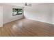 Well-lit bedroom with hardwood floors and a large window at 2587 Forest Run Ct # 141B, Clearwater, FL 33761