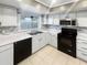 Modern kitchen with white cabinets, stainless steel appliances, and tile flooring at 2587 Forest Run Ct # 141B, Clearwater, FL 33761