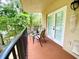 Private balcony with two chairs and small table, overlooking trees at 1420 Bayshore Blvd # 316, Dunedin, FL 34698