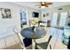 Small dining area with round table and four chairs, adjacent to living room at 1420 Bayshore Blvd # 316, Dunedin, FL 34698